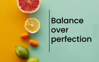 Colorful fruits arranged beside the words “Balance over perfection,” representing a flexible, non-restrictive approach to food and eating